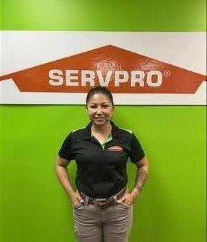 Brown-eyed, dark haired lady with hair tied back wearing collared SERVPRO uniform shirt